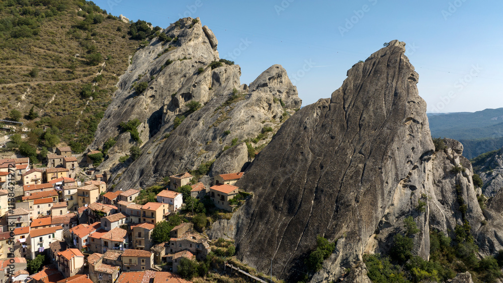 Aerial view of Castelmezzano, in the province of Potenza, Basilicata, Italy. It is a town built under the peak of a mountain in the Dolomiti Lucane park. Aerial view of Castelmezzano, in the province of Potenza, Basilicata, Italy. It is a town built under the peak of a mountain in the Dolomiti Lucane park.