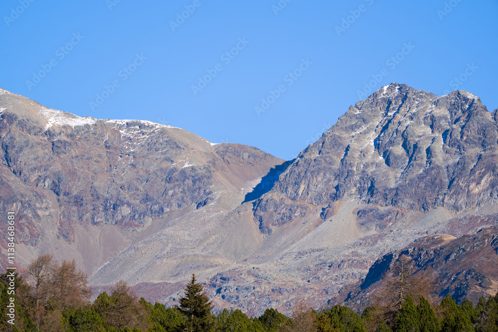 Scenic view of mountain panorama in the Swiss Alps at Engadin Valley seen from Swiss mountain village of Maloja on a sunny autumn day. Photo take November 15th, 2024, Maloja Bregaglia, Switzerland. Scenic view of mountain panorama in the Swiss Alps at Engadin Valley seen from Swiss mountain village of Maloja on a sunny autumn day. Photo take November 15th, 2024, Maloja Bregaglia, Switzerland.