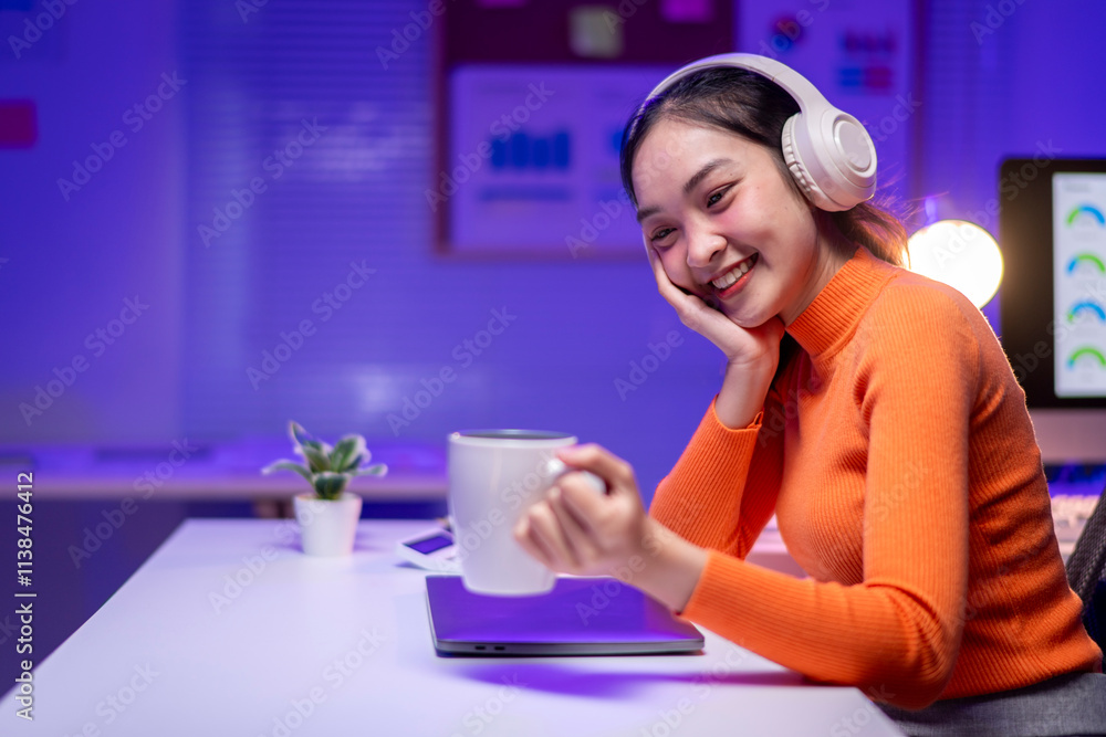 A woman wearing headphones and holding a cup of coffee A woman wearing headphones and holding a cup of coffee