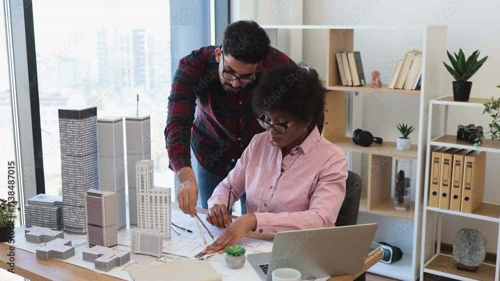 Indian man and African woman architects collaborate on model project for modern city. Diverse teamwork in bright office setting with creative discussion and urban planning focus. Indian man and African woman architects collaborate on model project for modern city. Diverse teamwork in bright office setting with creative discussion and urban planning focus.