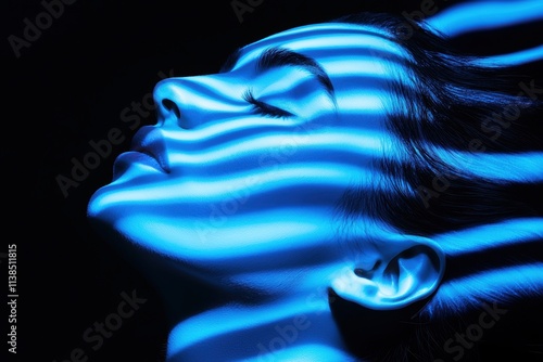 Profile of a person illuminated by rippling blue light patterns symbolizing calmness, thoughtfulness, and the fluid nature of perception photo