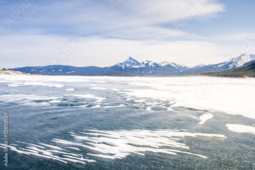 Winter landscape with mountains and frozen Lake.