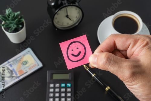 Business concept with a smile emoji on black background