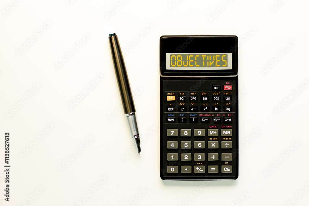 Objectives symbol. Concept word Objectives on beautiful black calculator. Beautiful white paper background. Beautiful black pen. Business objectives concept. Copy space. Objectives symbol. Concept word Objectives on beautiful black calculator. Beautiful white paper background. Beautiful black pen. Business objectives concept. Copy space.