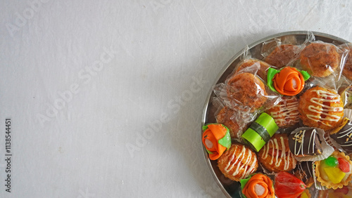 Assorted Decorative Sweets Arranged Neatly on a Round Metallic Tray photo