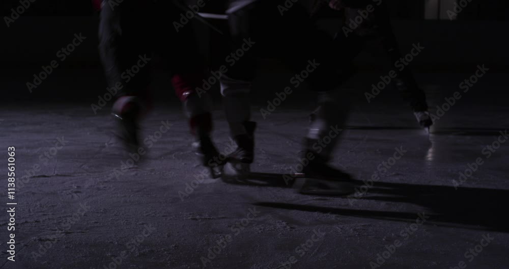 Ice hockey scene on dark rink dramatic players and goalie during a game Ice hockey scene on dark rink dramatic players and goalie during a game