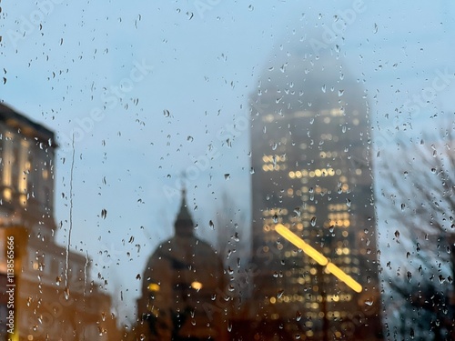 The raindrops on the window with downtown skyscrapers in the background. Montreal, Quebec, Canada