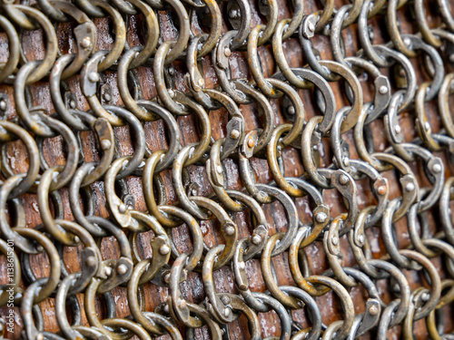 A fragment of chain mail made of riveted metal rings
