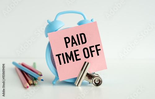 A blue alarm clock with pink writing on it that says Paid Time Off photo