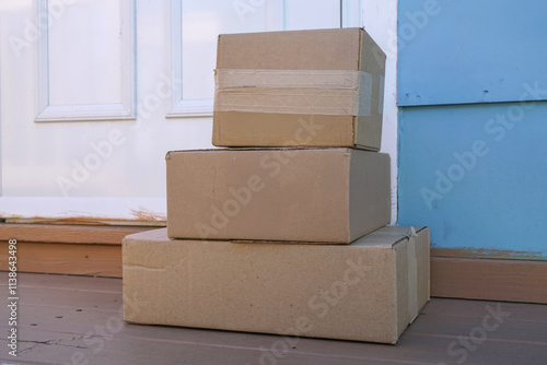 Fotografie delivered package boxes in front of the front door of house
