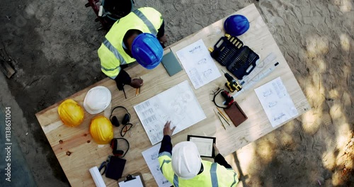 Above, people and paper on construction site for planning, urban development and project management with tech. Engineer team, blueprint or talking at equipment for building renovation in architecture photo