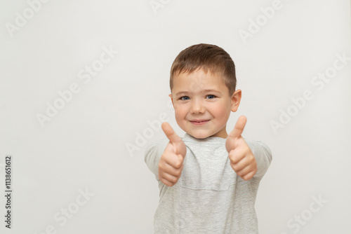 portrait of happy child on white background. little boy thumbs up, showing gesture - super. little blue-eyed boy with fair skin 5 years old photo