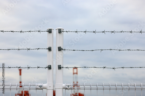 fence with Barb wire, metal chain with spike for safety and security purpose. photo