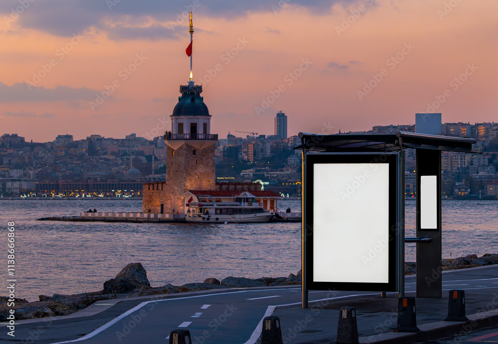 Maiden's Tower in the background and bus stop advertising board in the at sunset, Istanbul, Turkey