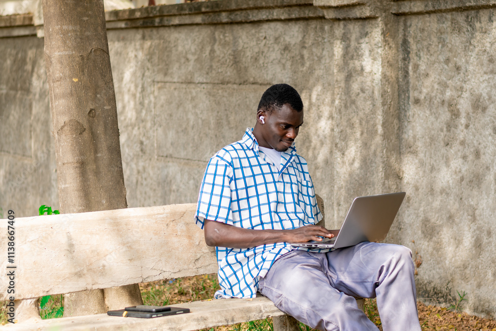 young African American man making use on laptop computer. young African American man making use on laptop computer.