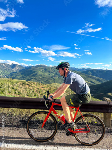 mountain bike rider on the road high above beaver creek in avon colorado 