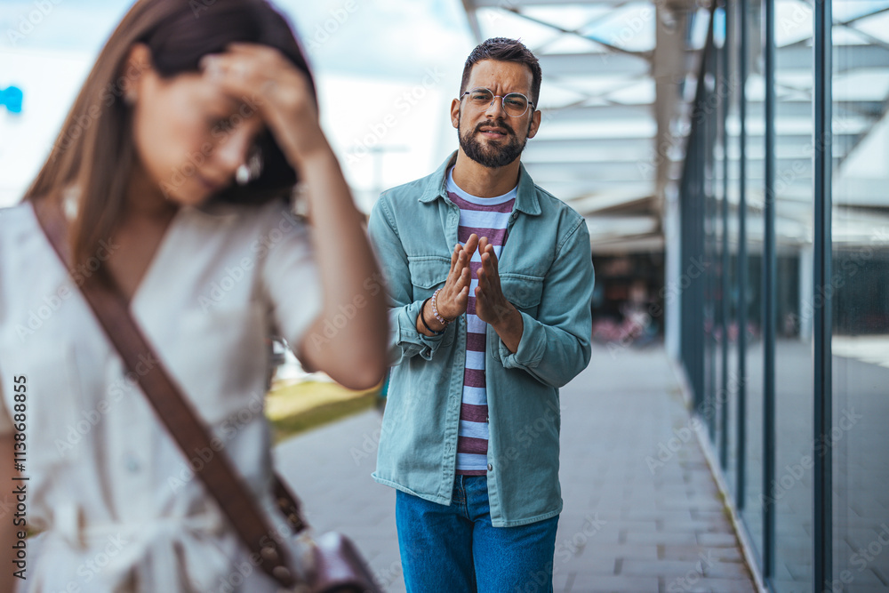 Man Apologizing to Upset Woman in Outdoor Urban Setting Man Apologizing to Upset Woman in Outdoor Urban Setting