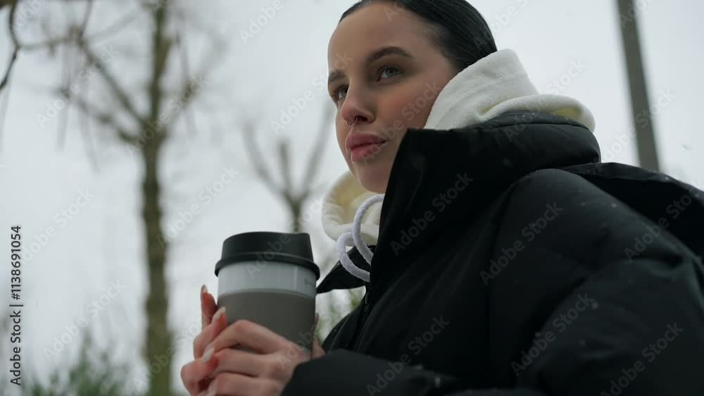 A girl in gloves holds a glass of hot tea in winter.
A girl with a thermal cup stands on the street in winter.
The girl is cold and warms herself with hot tea.
The girl froze while walking A girl in gloves holds a glass of hot tea in winter.
A girl with a thermal cup stands on the street in winter.
The girl is cold and warms herself with hot tea.
The girl froze while walking