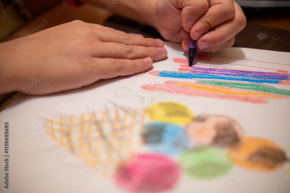 Fototapeta premium Draw with colored pencils on a white sheet of paper.