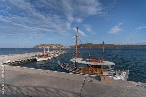 Fishing boats on the pier of Plaka. photo