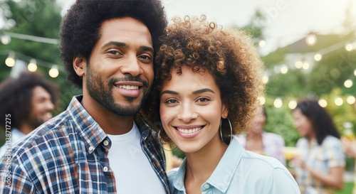 Joyful african american couple at outdoor summer celebration with friends