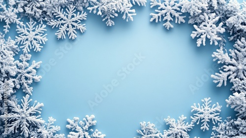 Winter wonderland background with snowflakes and pine branches on blue surface