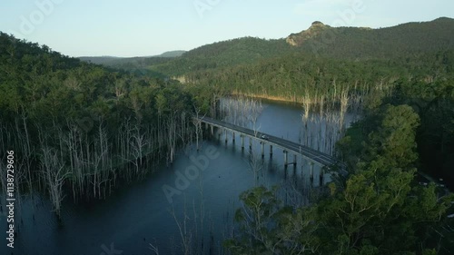 Wallpaper Mural Aerial view over a calm water with Pine Creek Bridge surrounded by vegetation and mountains Torontodigital.ca