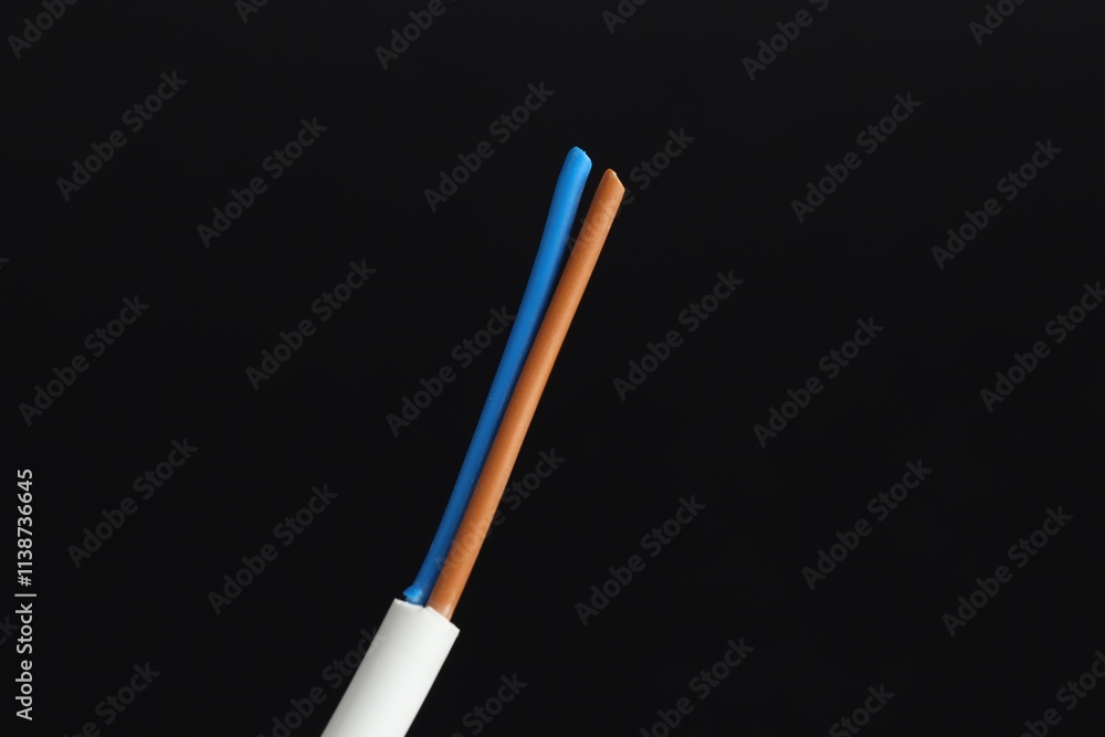 White stripped electrical wire on black background, closeup White stripped electrical wire on black background, closeup
