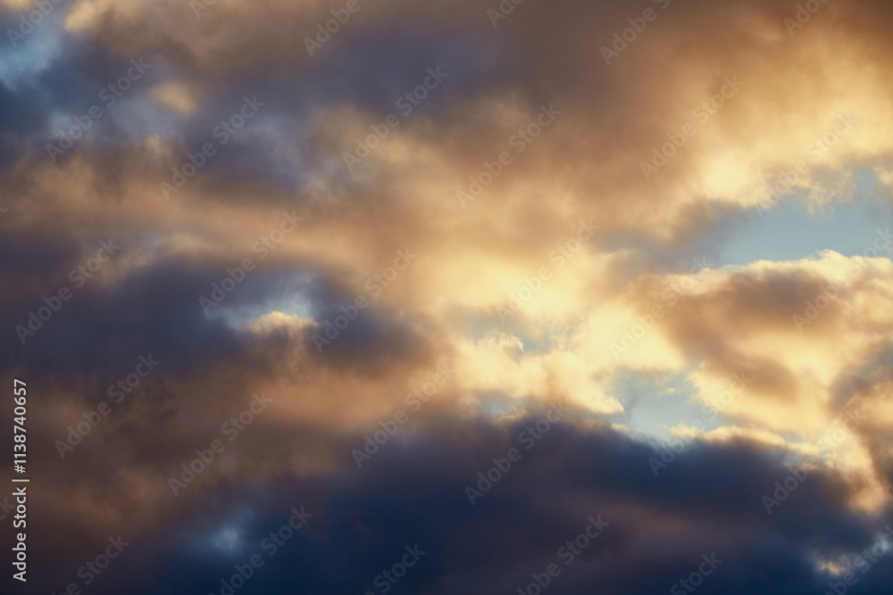 Calm winter sky with gray clouds softly lit by golden sunlight. Calm winter sky with gray clouds softly lit by golden sunlight.