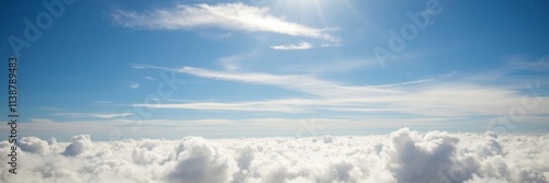 White fluffy clouds floating in the clear blue summer sky, creating a picturesque scene, horizontal, serene