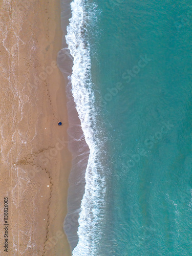 Fototapeta Naklejka Na Ścianę i Meble -  Sakarya Karasu High-angle view of a tranquil beach meeting turquoise waves. An aerial shot of a pristine beach meeting a turquoise ocean. ADAPAZARI Turkey Turkiye Aerial View Drone Shot nature 
