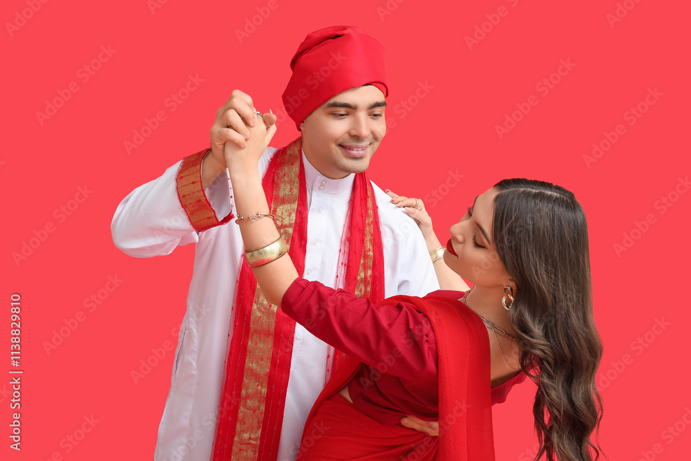Beautiful Indian couple dancing on red background Beautiful Indian couple dancing on red background