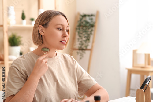 Woman using face massage ro...
