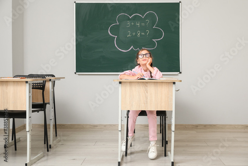 Thoughtful little schoolgir...