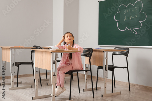 Thoughtful little schoolgir...