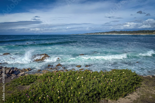 Scenic view of Pacific Ocean coastline seen from Spanish Bay Vista Point, Del Monte Forest, California, USA against blue sky with clouds