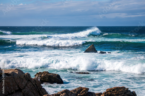 Obraz na płótnie Scenic view of Pacific Ocean waves at the coast seen from Spanish Bay Vista Point, Del Monte Forest, California, USA against blue sky with clouds w salonie