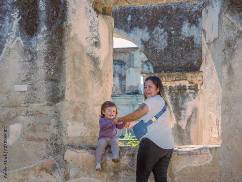 Fotografie Grandmother surprises her daughter while taking a photo of her and her granddaughter at a tourist location