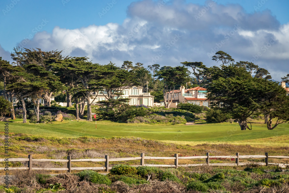 Scenic view rocky Pacific Ocean coast along 17-Mile-Drive looking south, Del Monte Forest, California, USA against blue sky with clouds