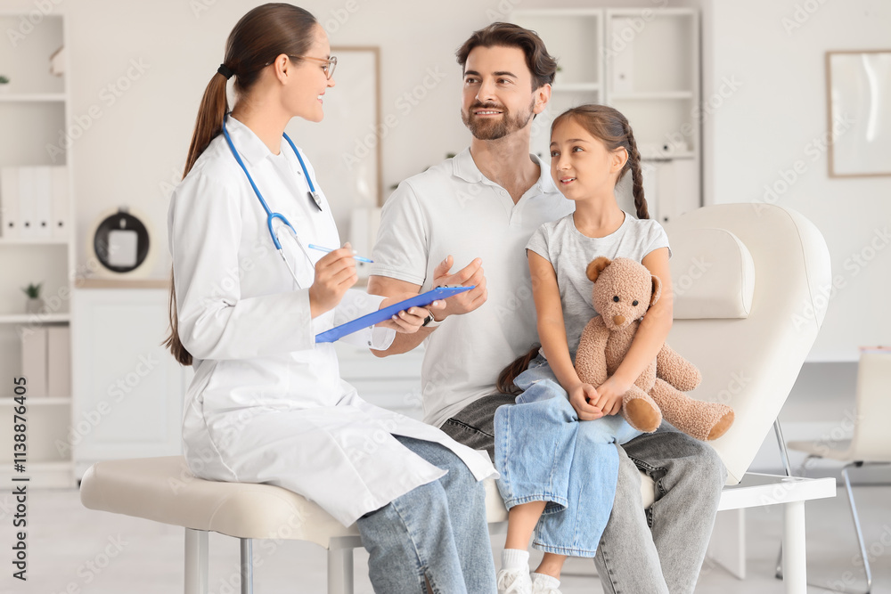 Female pediatrician working with girl and father in clinic Female pediatrician working with girl and father in clinic