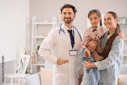 Male pediatrician and mother with her daughter at home photo