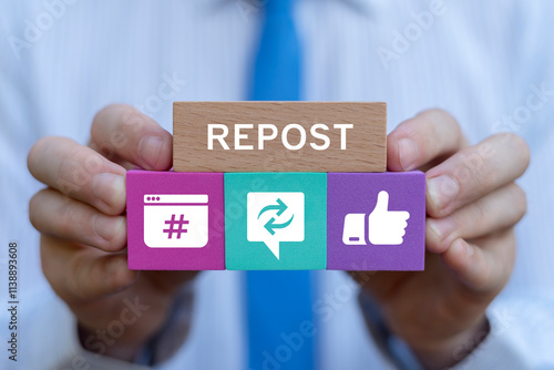 Obraz na płótnie Businessman holding colorful blocks with icons sees text: REPOST. Repost sharing viral content online concept. Repost social media web information technology. w salonie