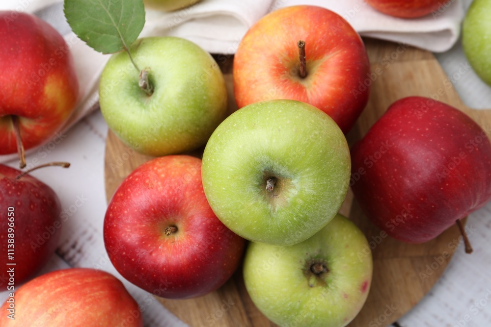 Different whole ripe apples on white wooden table, flat lay Different whole ripe apples on white wooden table, flat lay