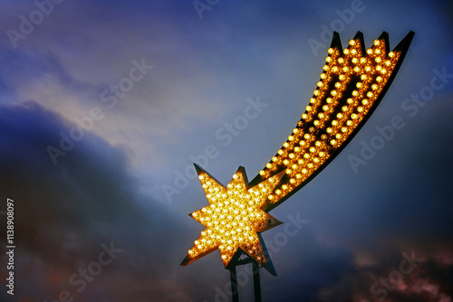 Light installation in the shape of the star of Bethlehem as Christmas decoration against a dark stormy sky, religious symbol in Christianity, copy space, selected focus photo