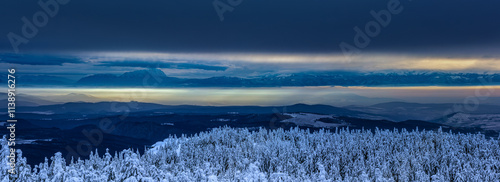 View from the Hargita mountains towards the Eastern Carpathians at sunset, Romania. You can see the Piatra Craiului mountains, the Fagarasi mountains, and a part of Bucegi. photo