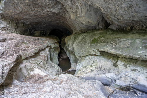 Cavernous rock formations in the shape of a gorge belonging to the source of the river Alviela where it is possible to watch the water photo