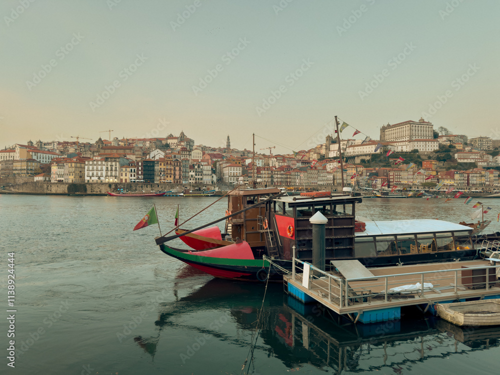 Obraz premium Traditional Rabelo boats, once used to transport port wine along the Douro River, now symbolize Portugal s rich winemaking heritage.