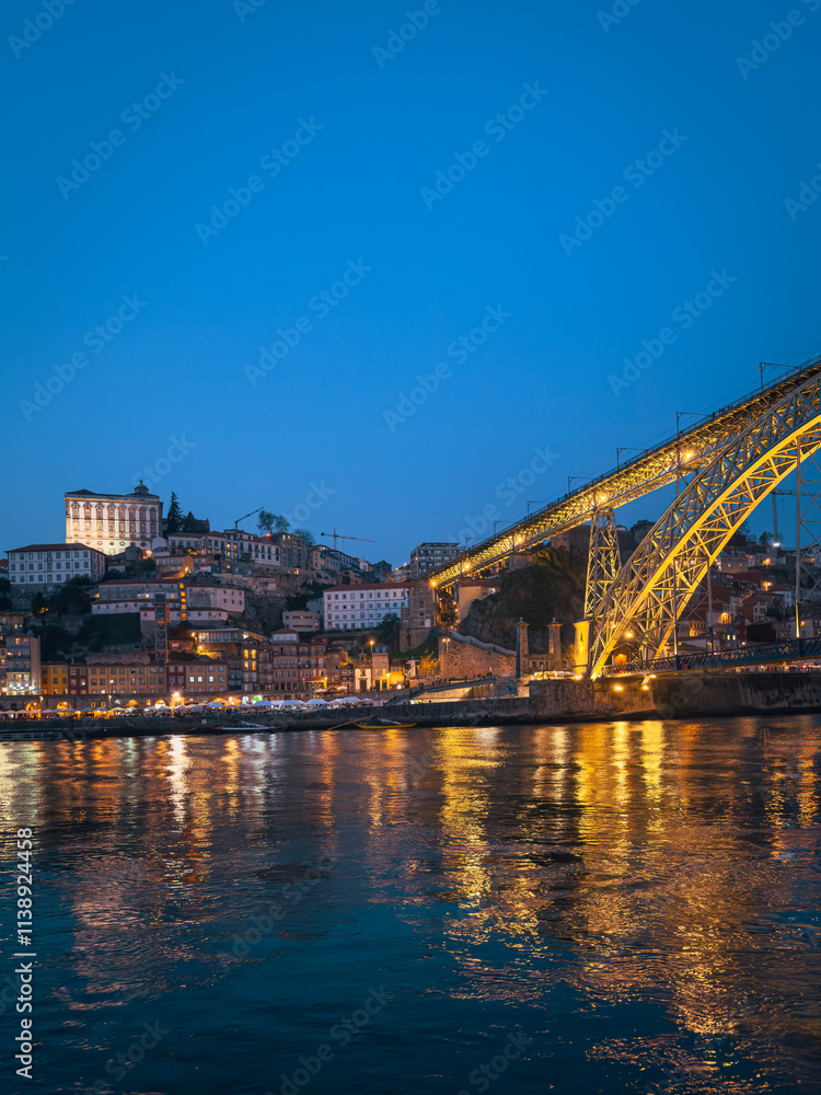 Obraz premium The iconic Dom Luís I Bridge, illuminated against the night sky, stands as a symbol of Porto s industrial heritage and architectural beauty.