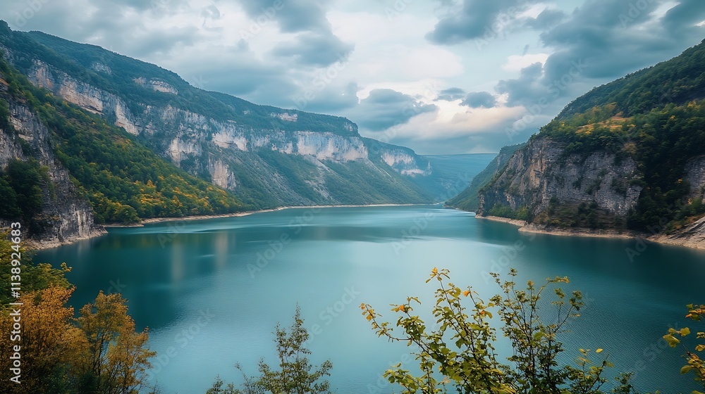 Obraz premium Serene Mountain Lake Landscape. Scenic view of a tranquil alpine lake nestled between towering mountains.
