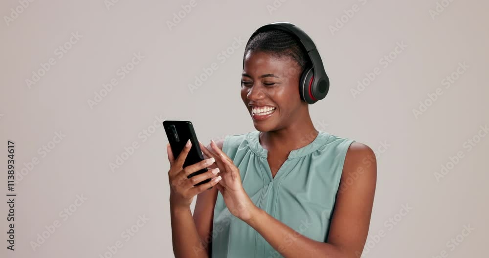 Black woman, headphones and phone with dancing in studio, happy and listening to music by background. Girl, person and smartphone with streaming, subscription and excited with mobile app for sound Black woman, headphones and phone with dancing in studio, happy and listening to music by background. Girl, person and smartphone with streaming, subscription and excited with mobile app for sound
